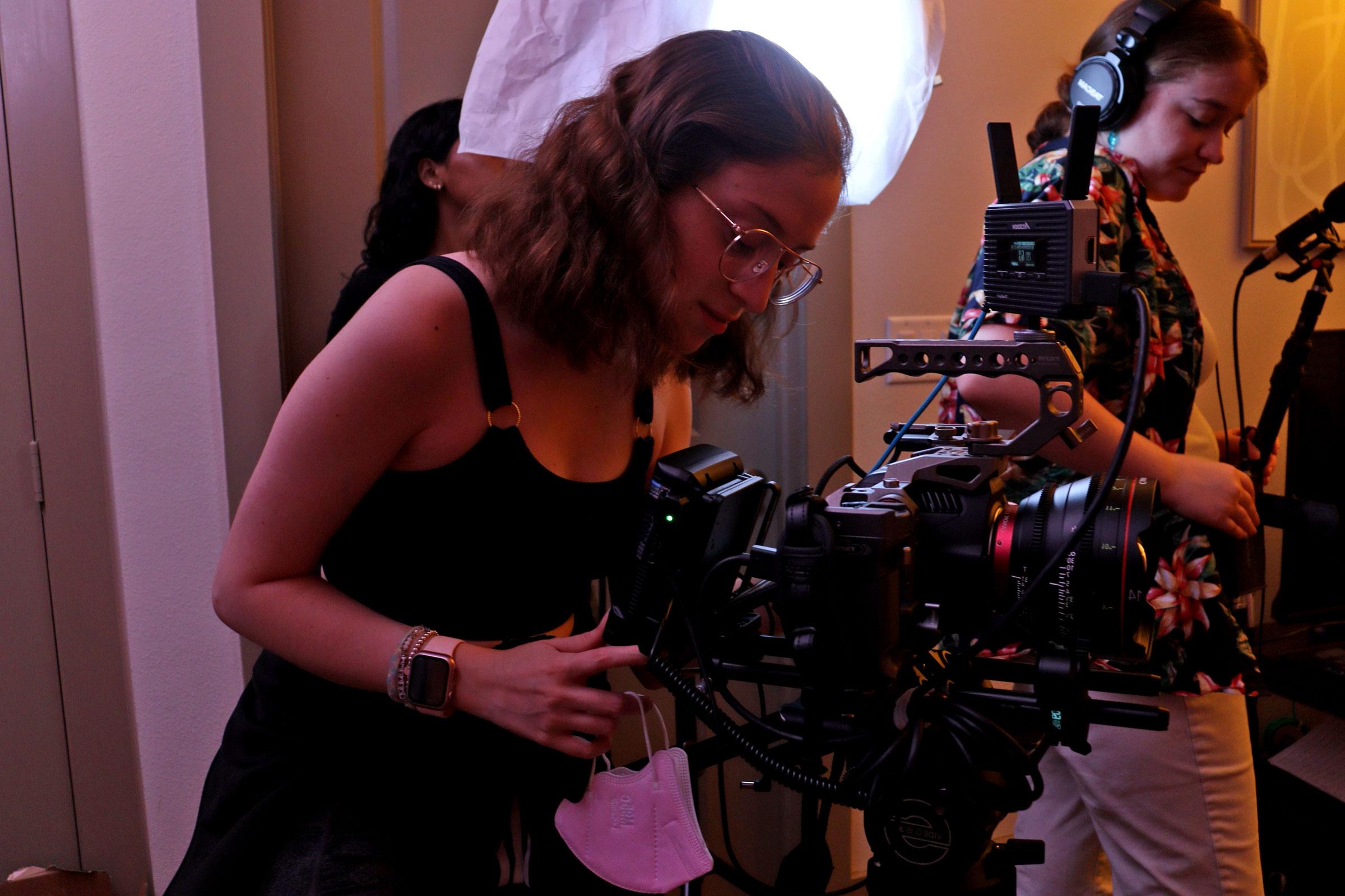 A crew member operates a camera on set of the new film, "十字路口."